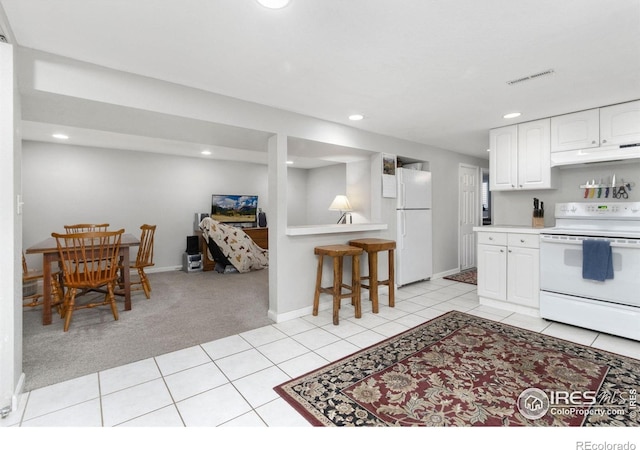 408 Riddle Dr, Fort Collins, CO 80521 - kitchen featuring white appliances, under cabinet range hood, white cabinets, recessed lighting, and light carpet