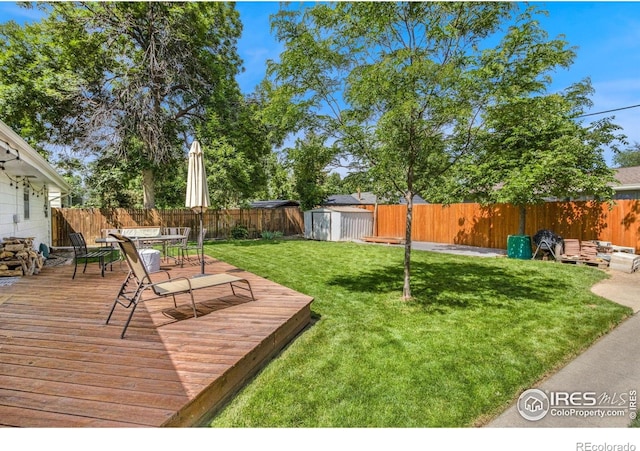 408 Riddle Dr, Fort Collins, CO 80521 - fenced backyard with a storage unit, a deck, and outdoor dining area