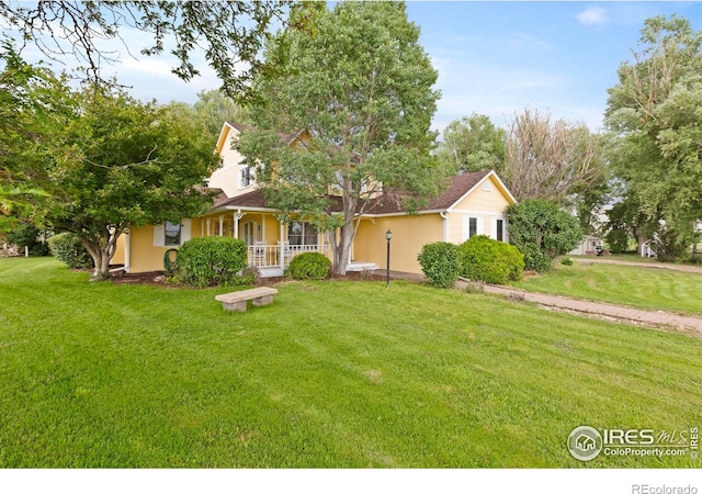 991 Peaceful View Pl, Johnstown, CO 80534 - view of front of house featuring a porch and a front yard