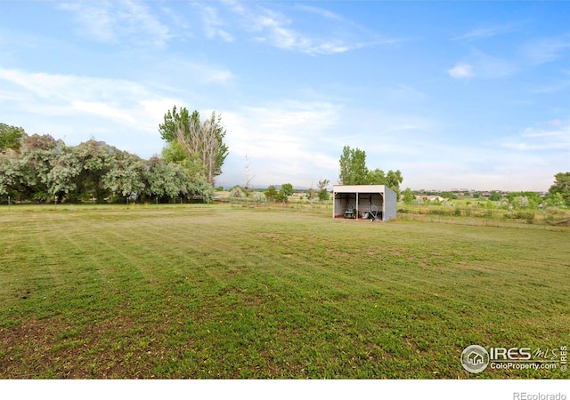 991 Peaceful View Pl, Johnstown, CO 80534 - view of grassy yard featuring an outbuilding, an outdoor structure, and a carport