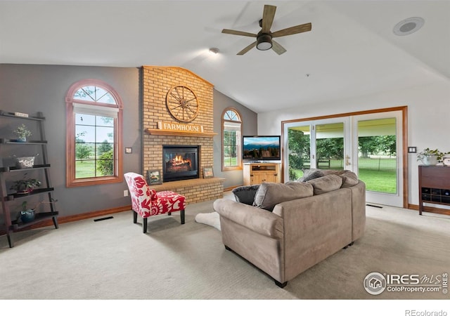 991 Peaceful View Pl, Johnstown, CO 80534 - living room featuring vaulted ceiling, carpet flooring, ceiling fan, healthy amount of natural light, and a brick fireplace