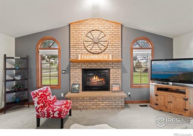 991 Peaceful View Pl, Johnstown, CO 80534 - carpeted living area featuring lofted ceiling, a brick fireplace, and plenty of natural light