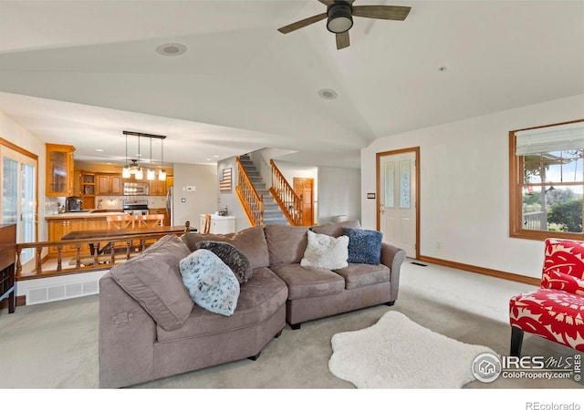 991 Peaceful View Pl, Johnstown, CO 80534 - living area featuring light colored carpet, stairway, ceiling fan, and lofted ceiling