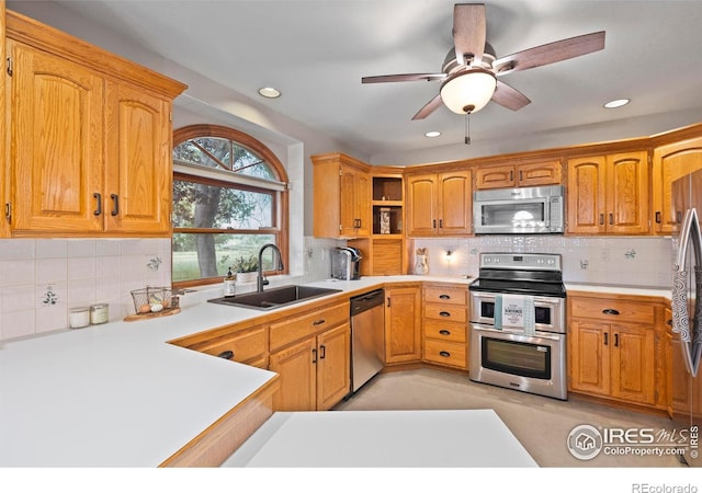 991 Peaceful View Pl, Johnstown, CO 80534 - kitchen featuring stainless steel appliances, open shelves, tasteful backsplash, ceiling fan, and light countertops
