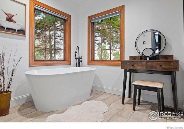 991 Peaceful View Pl, Johnstown, CO 80534 - full bathroom featuring a soaking tub, wood finished floors, and vanity
