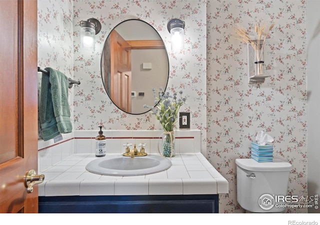 991 Peaceful View Pl, Johnstown, CO 80534 - half bathroom with wallpapered walls and vanity