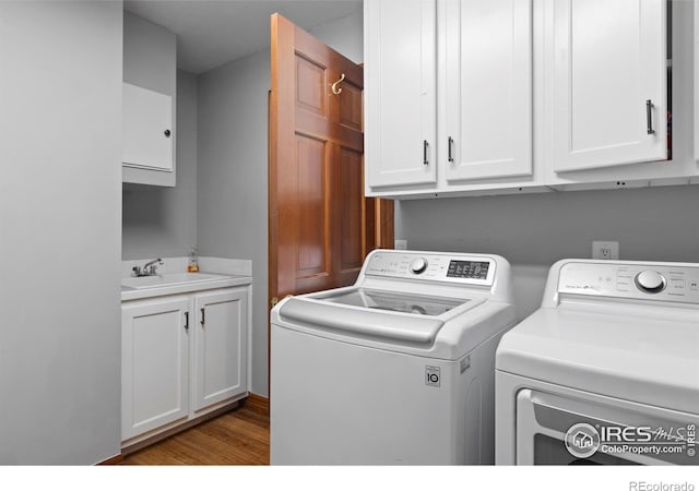 991 Peaceful View Pl, Johnstown, CO 80534 - washroom featuring cabinet space, washer and clothes dryer, and wood finished floors