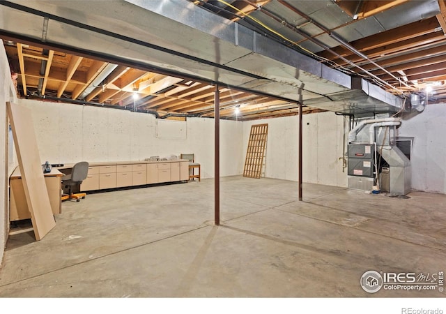 991 Peaceful View Pl, Johnstown, CO 80534 - unfinished below grade area featuring heating unit and an office area
