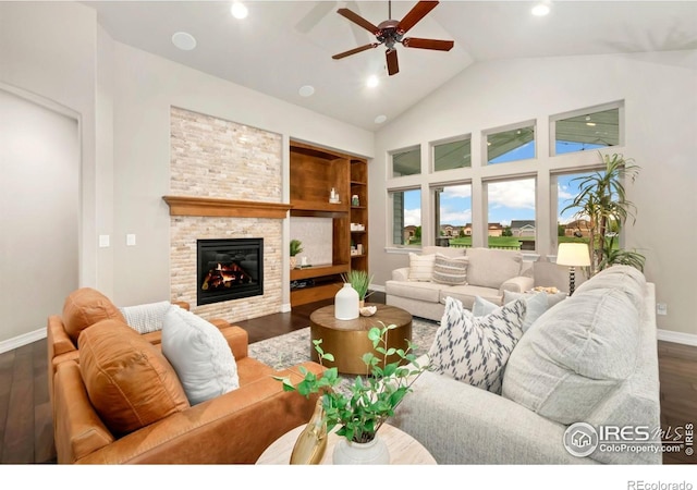 5954 Black Lion Ct, Windsor, CO 80550 - living area featuring wood finished floors, ceiling fan, a stone fireplace, high vaulted ceiling, and recessed lighting