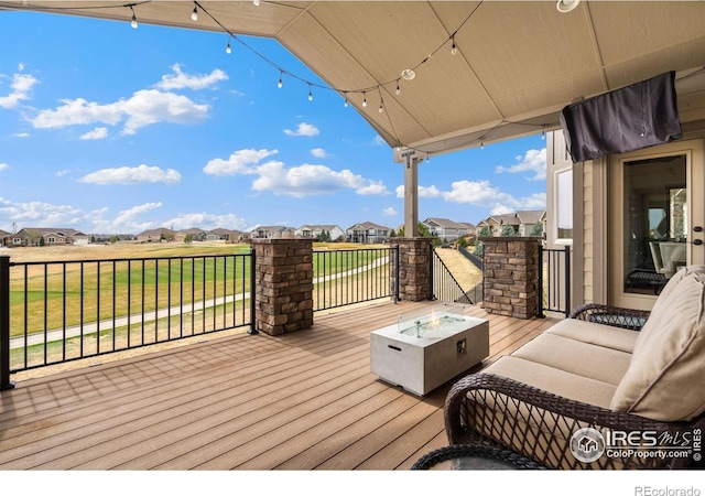 5954 Black Lion Ct, Windsor, CO 80550 - wooden terrace featuring an outdoor fire pit and a residential view