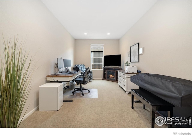 4822 Wildflower Pl, Dacono, CO 80514 - home office with light carpet, recessed lighting, and a warm lit fireplace