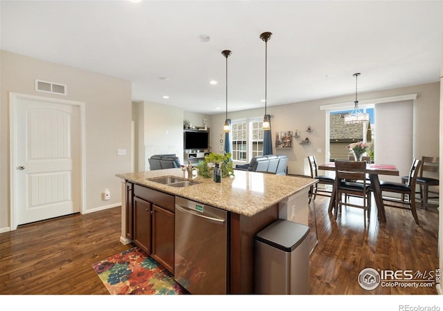 4822 Wildflower Pl, Dacono, CO 80514 - kitchen featuring dishwasher, dark wood-style flooring, light stone counters, open floor plan, and pendant lighting
