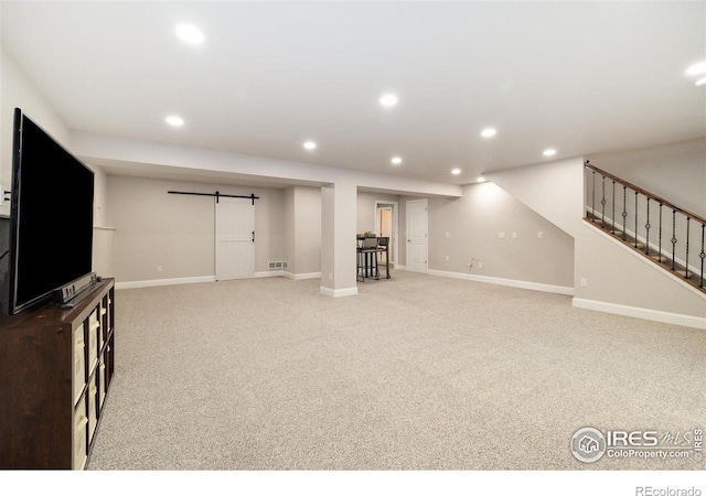 4822 Wildflower Pl, Dacono, CO 80514 - unfurnished living room with a barn door, carpet, stairway, and recessed lighting