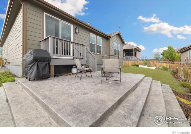 4822 Wildflower Pl, Dacono, CO 80514 - fenced backyard featuring a grill and a patio area