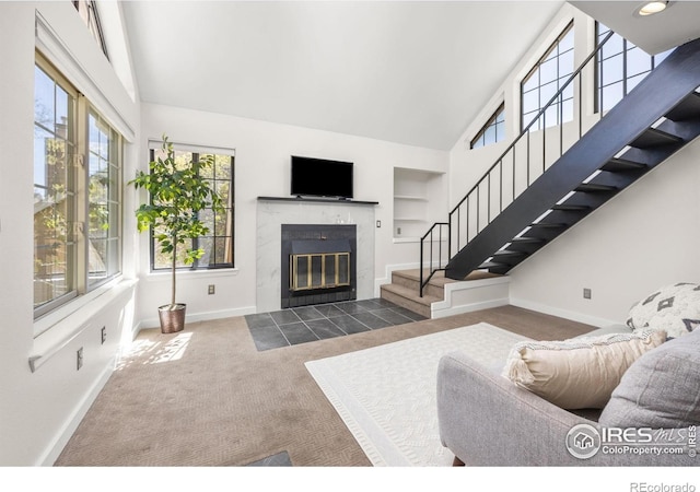 5904 Gunbarrel Ave Unit B, Boulder, CO 80301 - carpeted living area featuring stairway, a tile fireplace, built in features, and high vaulted ceiling