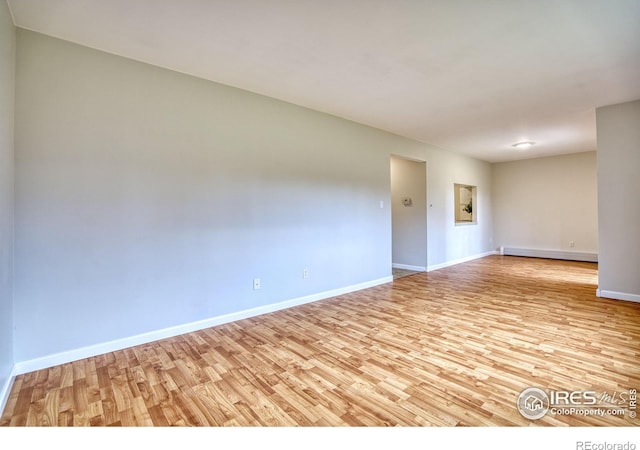 801 E Drake Rd Unit G77, Fort Collins, CO 80525 - spare room featuring a baseboard radiator and light wood finished floors