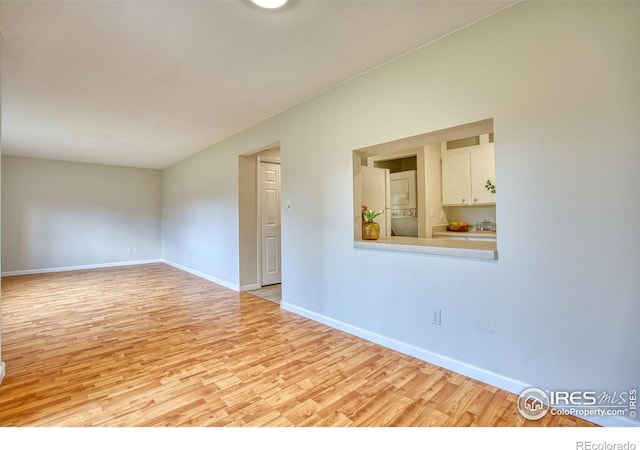 801 E Drake Rd Unit G77, Fort Collins, CO 80525 - unfurnished room with stacked washer and clothes dryer and wood finished floors