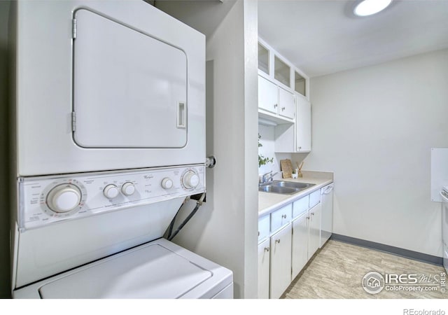 801 E Drake Rd Unit G77, Fort Collins, CO 80525 - laundry room featuring stacked washing machine and dryer and a sink