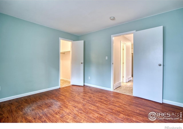 801 E Drake Rd Unit G77, Fort Collins, CO 80525 - unfurnished bedroom featuring wood finished floors and a spacious closet