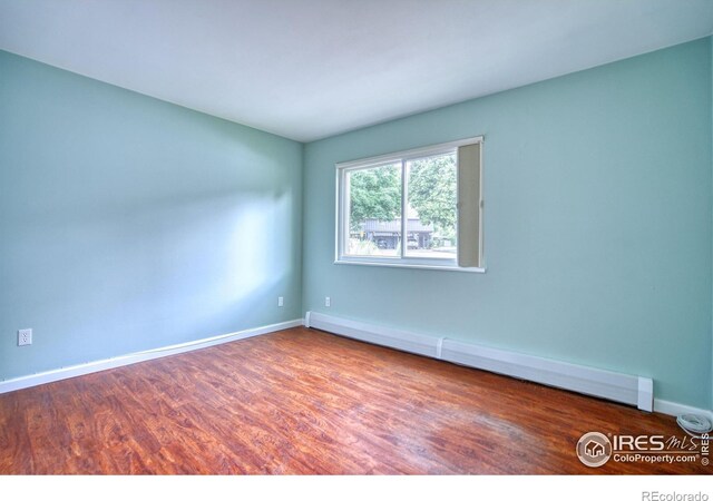 801 E Drake Rd Unit G77, Fort Collins, CO 80525 - unfurnished room with a baseboard radiator and wood finished floors