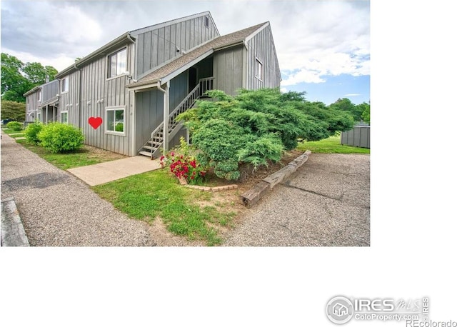 801 E Drake Rd Unit G77, Fort Collins, CO 80525 - view of front of property with stairway and board and batten siding