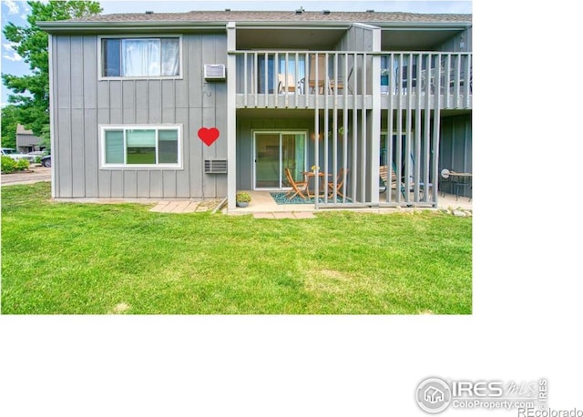 801 E Drake Rd Unit G77, Fort Collins, CO 80525 - rear view of house featuring board and batten siding, a balcony, a lawn, and a patio area