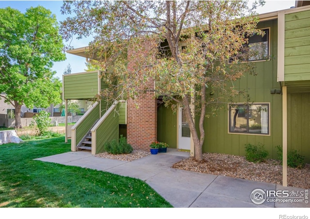 1410 Bacchus Dr Unit B12, Lafayette, CO 80026 - property entrance with a yard
