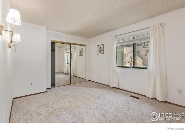 1410 Bacchus Dr Unit B12, Lafayette, CO 80026 - unfurnished bedroom featuring carpet, a textured ceiling, and a closet
