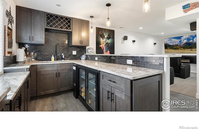 3007 45th Ave, Greeley, CO 80634 - kitchen with wine cooler, a peninsula, wood finished floors, tasteful backsplash, and recessed lighting