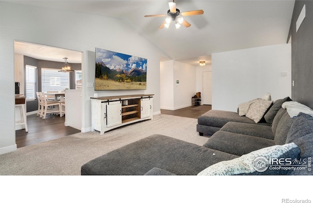 3007 45th Ave, Greeley, CO 80634 - living room featuring a ceiling fan, carpet flooring, vaulted ceiling, and a chandelier