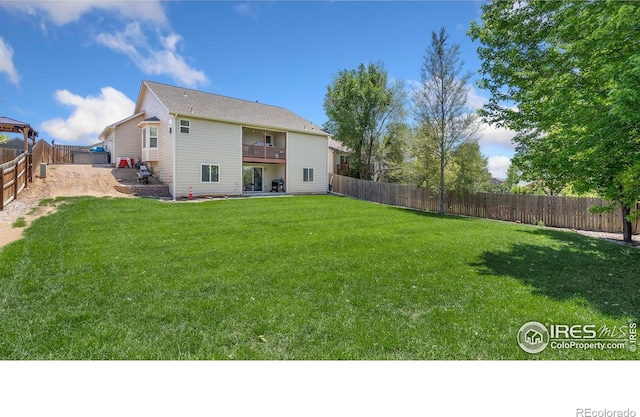 3007 45th Ave, Greeley, CO 80634 - back of house featuring a fenced backyard, a balcony, and a patio