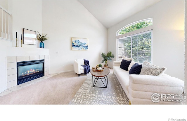 1839 Laurus Ln, Johnstown, CO 80534 - living area with high vaulted ceiling, carpet floors, and a fireplace