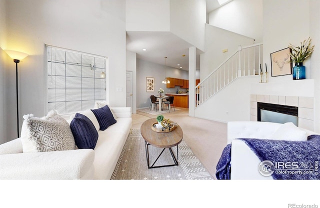 1839 Laurus Ln, Johnstown, CO 80534 - living room featuring a towering ceiling, stairway, and carpet floors