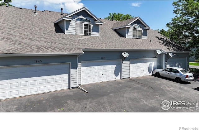 1839 Laurus Ln, Johnstown, CO 80534 - view of front of house with a shingled roof and driveway