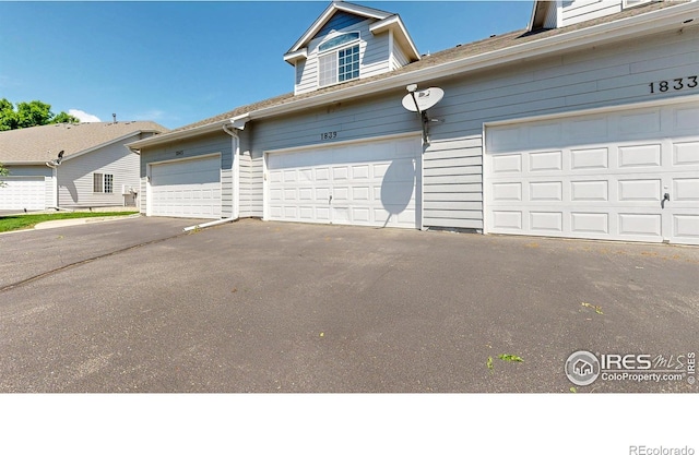 1839 Laurus Ln, Johnstown, CO 80534 - garage with asphalt driveway