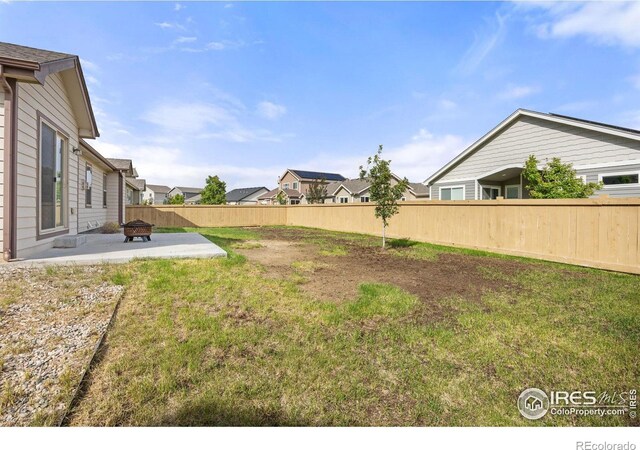 6818 Meadow Rain Way, Wellington, CO 80549 - fenced backyard with a patio area, an outdoor fire pit, and a residential view