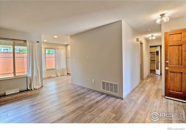 3405 W 16th St Unit 30, Greeley, CO 80634 - spare room with light wood finished floors, a textured ceiling, and recessed lighting