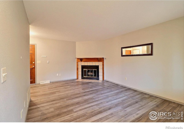3405 W 16th St Unit 30, Greeley, CO 80634 - unfurnished living room featuring light wood-style floors and a fireplace