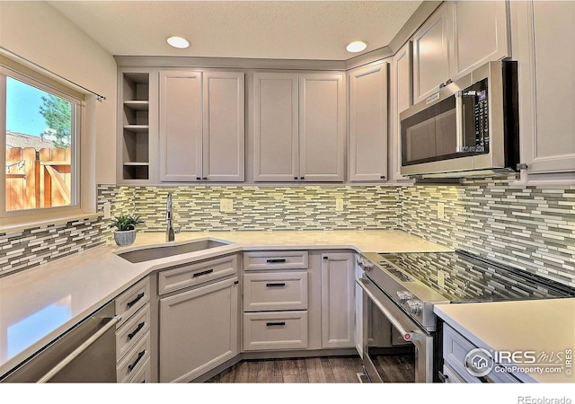3405 W 16th St Unit 30, Greeley, CO 80634 - kitchen featuring stainless steel appliances, light countertops, tasteful backsplash, wood finished floors, and recessed lighting