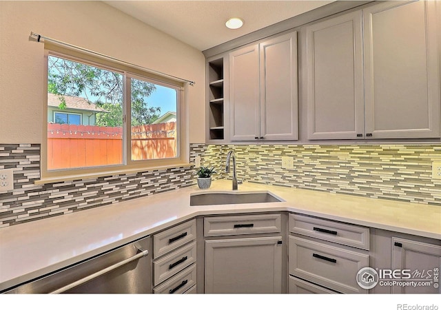 3405 W 16th St Unit 30, Greeley, CO 80634 - kitchen featuring stainless steel dishwasher, light countertops, backsplash, gray cabinetry, and recessed lighting