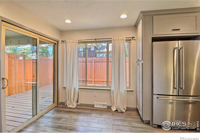 3405 W 16th St Unit 30, Greeley, CO 80634 - kitchen with high quality fridge, light wood-style flooring, gray cabinets, recessed lighting, and a textured ceiling