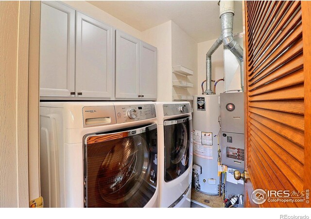 3405 W 16th St Unit 30, Greeley, CO 80634 - washroom featuring gas water heater, cabinet space, and washing machine and dryer