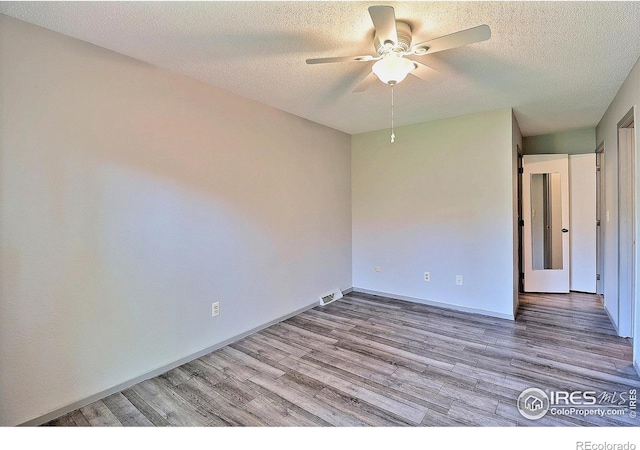 3405 W 16th St Unit 30, Greeley, CO 80634 - empty room with wood finished floors, ceiling fan, and a textured ceiling