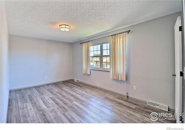 3405 W 16th St Unit 30, Greeley, CO 80634 - unfurnished room with wood finished floors and a textured ceiling