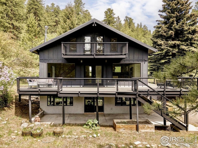 781 Cold Springs Rd, Nederland, CO 80466 - rear view of property featuring a balcony, a patio area, board and batten siding, and a deck