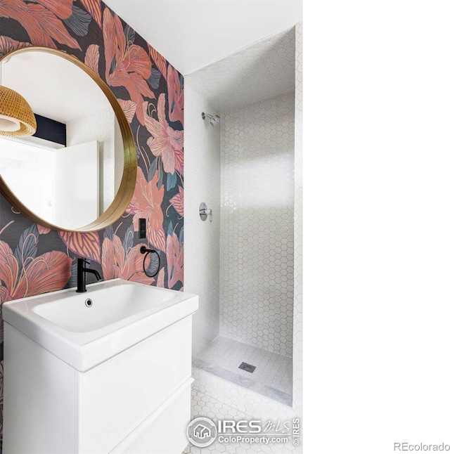 781 Cold Springs Rd, Nederland, CO 80466 - bathroom featuring a stall shower, vanity, wallpapered walls, and tile patterned floors