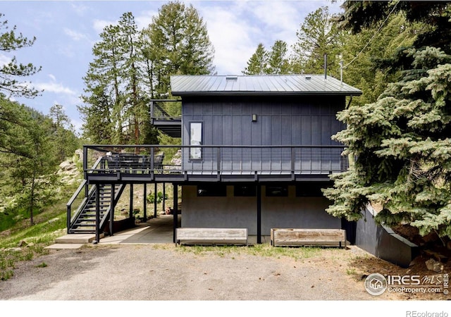 781 Cold Springs Rd, Nederland, CO 80466 - rear view of property featuring a deck, stairs, and a metal roof