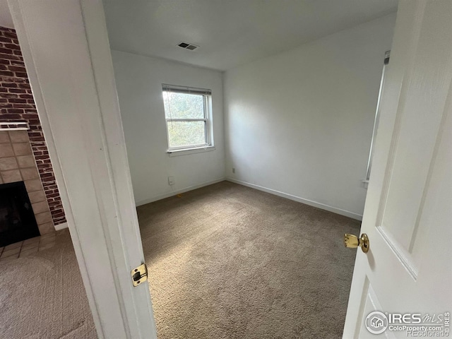 225 E 8th Ave Unit B11, Longmont, CO 80504 - unfurnished bedroom featuring carpet and a brick fireplace