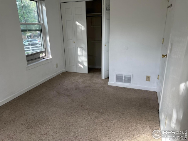 225 E 8th Ave Unit B11, Longmont, CO 80504 - unfurnished bedroom with carpet floors, multiple windows, and a closet