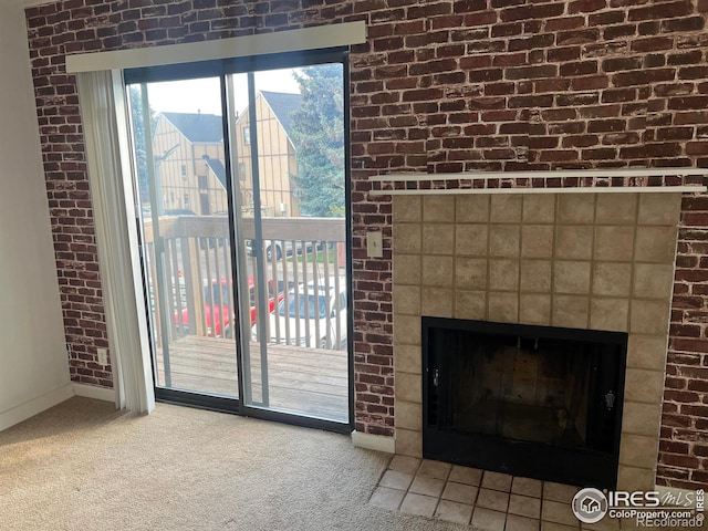 225 E 8th Ave Unit B11, Longmont, CO 80504 - detailed view of carpet flooring, a fireplace, and brick wall